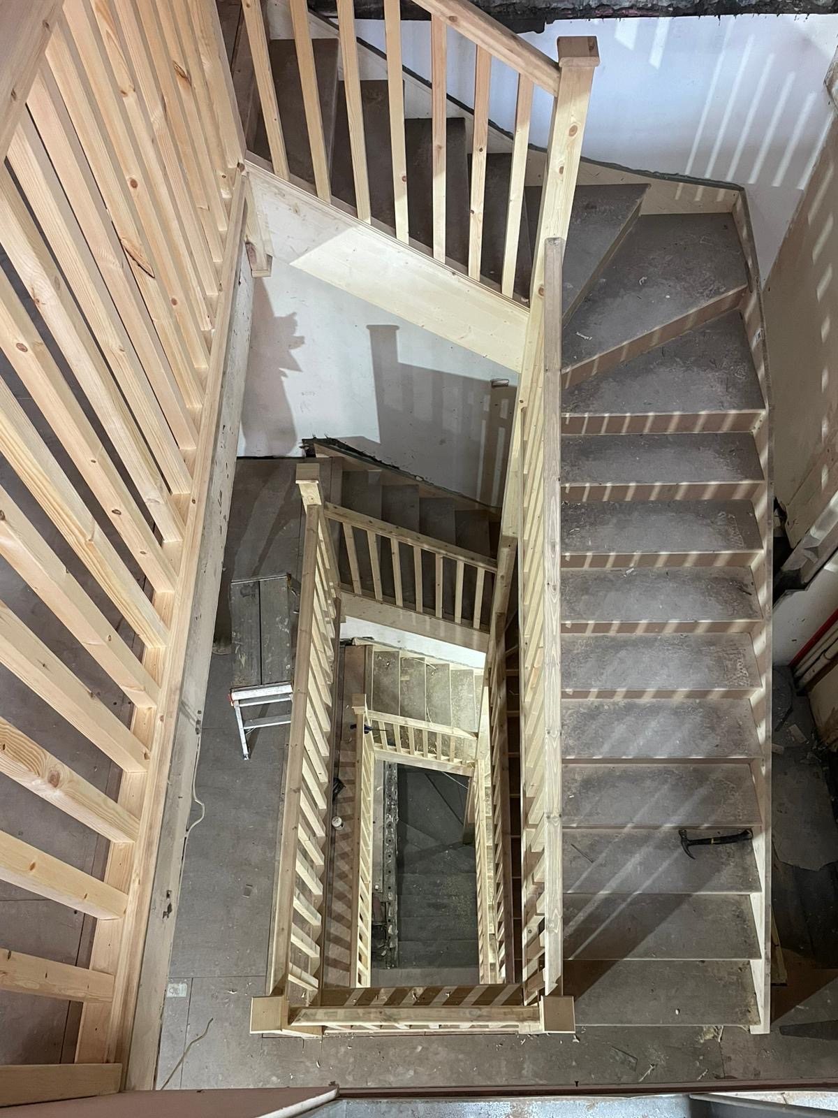Bespoke timber staircase under construction across multiple flights